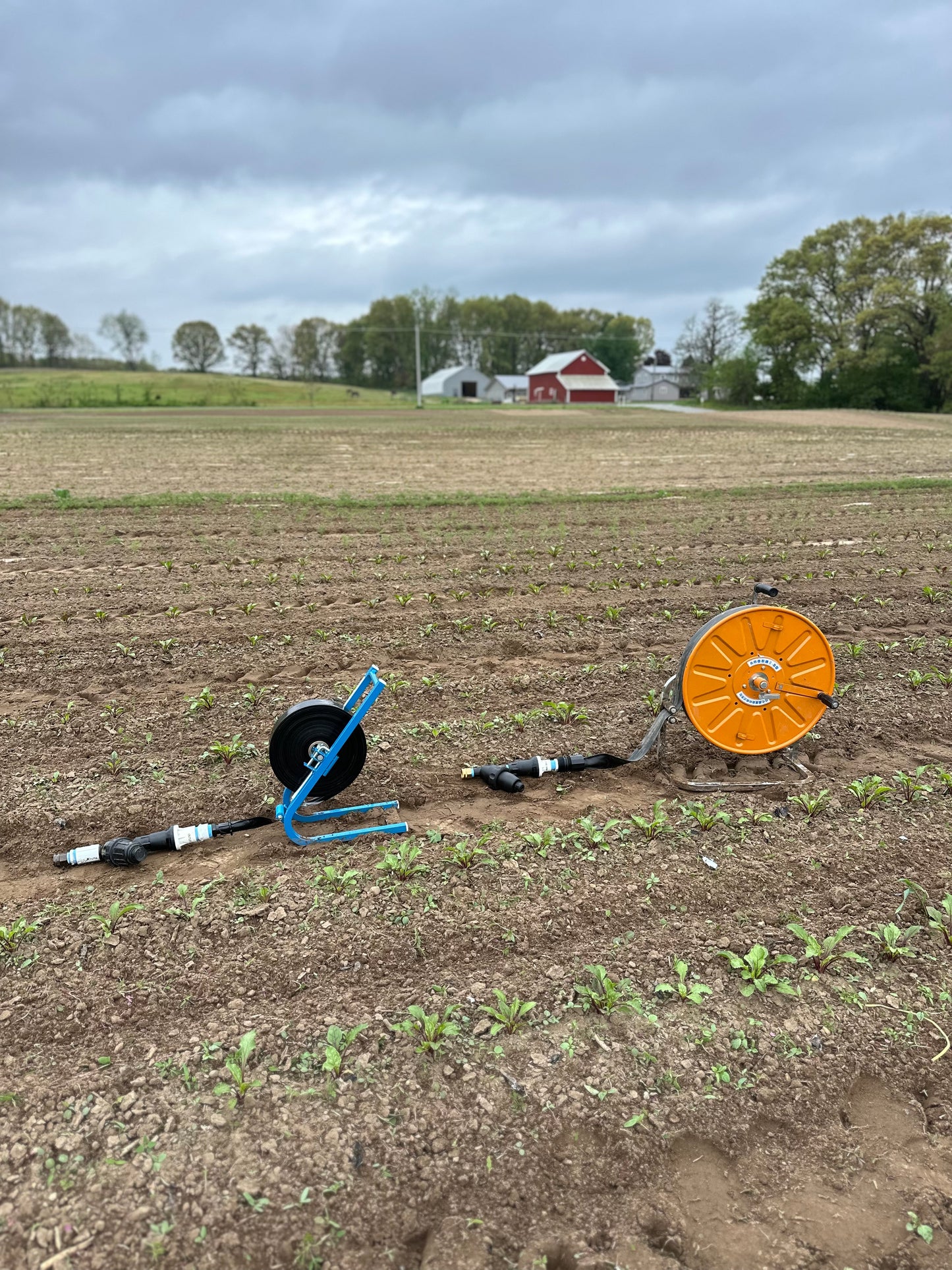 Sumisansui Mark 2 on M Winder with garden hose connect kit and Sumisansui R-Wide 'sumi soaker sumisoaker max' with R Winder and garden hose connect kit in freshly cultivated field.