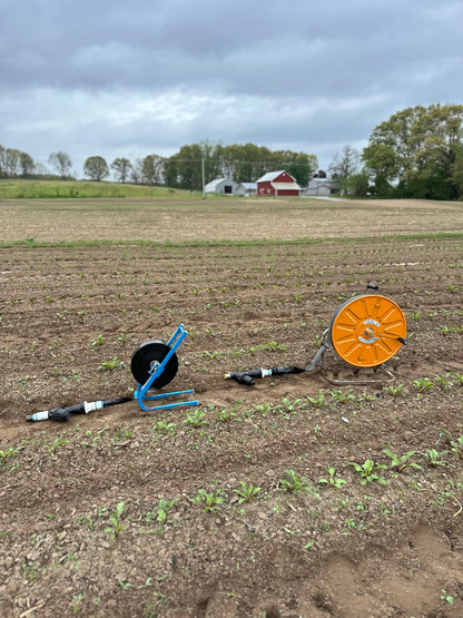 Sumisansui Mark 2 on M Winder with garden hose connect kit and Sumisansui R-Wide 'sumi soaker sumisoaker max' with R Winder and garden hose connect kit in freshly cultivated field.